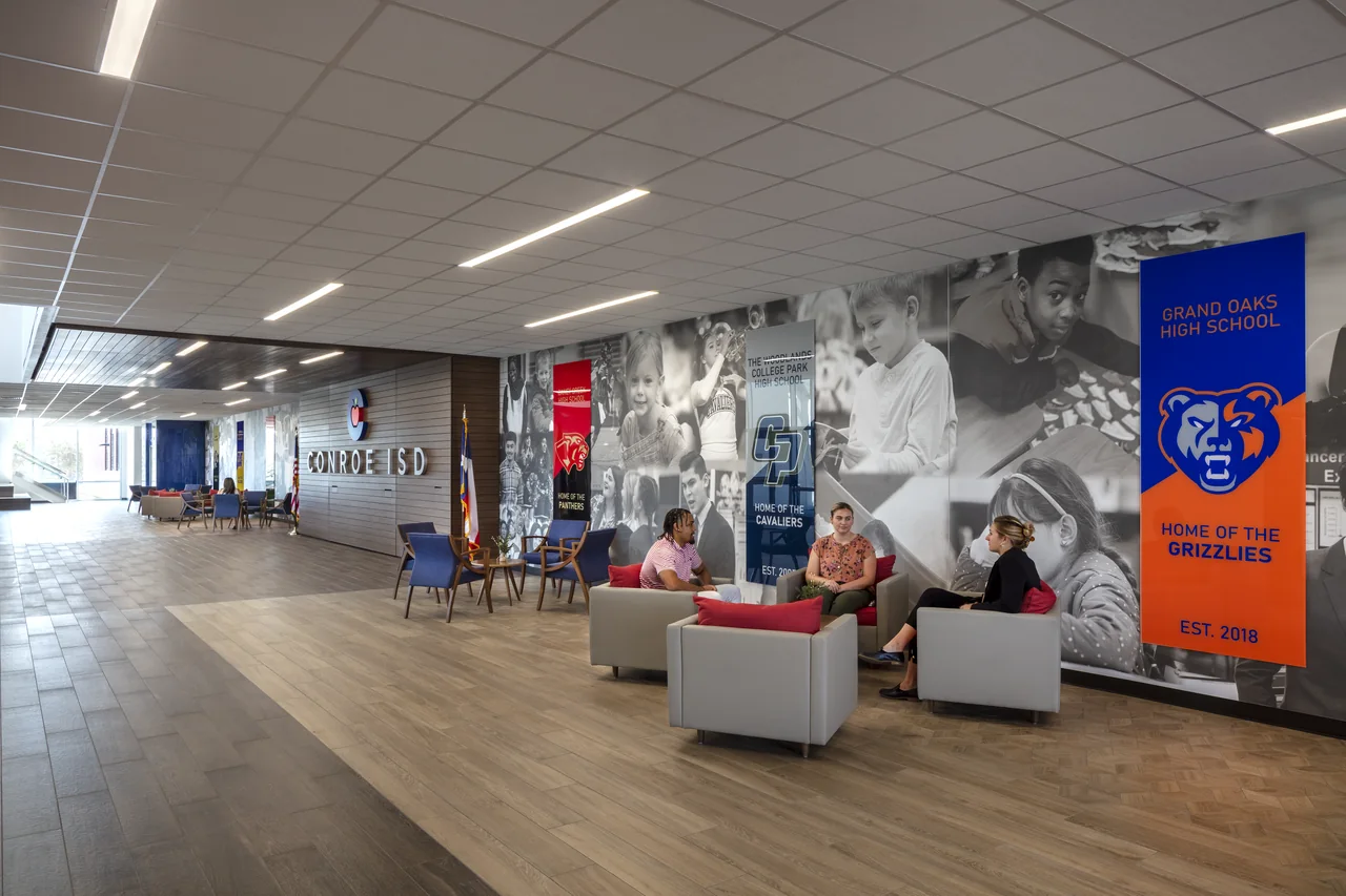 Lounge seating and district graphics line the center’s main circulation space.