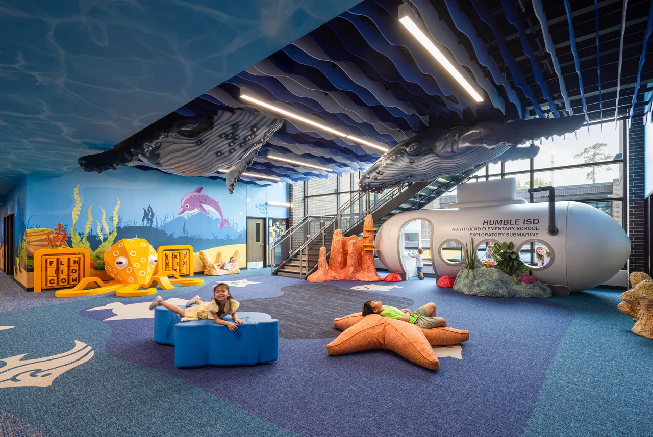 Marine learning environment with a submarine, colorful seating and a flowing blue ceiling.